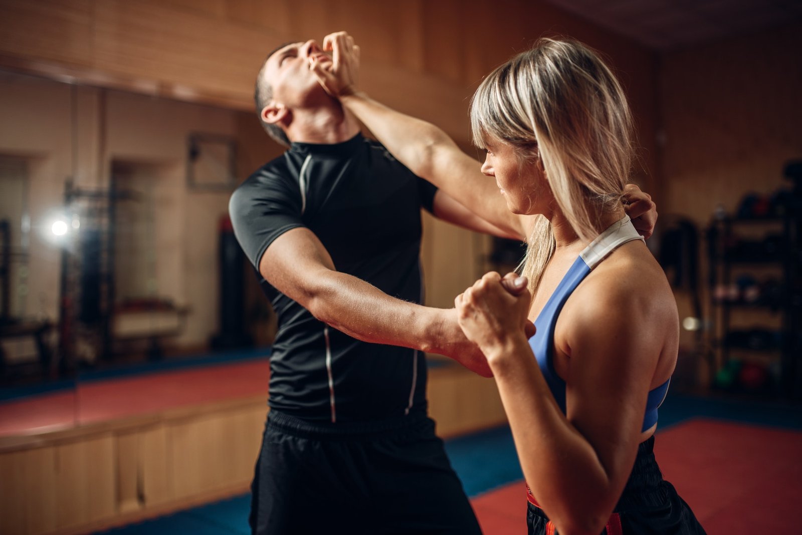 Female person on self-defense workout with trainer